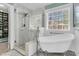 Well-lit bathroom featuring a soaking tub, glass shower, and modern fixtures, creating a relaxing retreat at 1728 Wellstead St, Mount Pleasant, SC 29466
