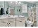Bright bathroom featuring a double vanity, a large mirror, and a shower-tub combination at 1728 Wellstead St, Mount Pleasant, SC 29466