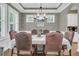 Traditional dining room with chandelier, white trim, and six leather chairs at 1728 Wellstead St, Mount Pleasant, SC 29466