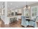 Eat-in kitchen and dining room with granite countertops, hardwood floors, and ample lighting at 1728 Wellstead St, Mount Pleasant, SC 29466