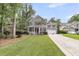 Charming two-story home with a inviting front porch, attached garage, and a beautiful, green lawn at 1728 Wellstead St, Mount Pleasant, SC 29466