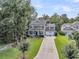 Beautiful two-story home with well-maintained landscaping and a long driveway leading to a two-car garage at 1728 Wellstead St, Mount Pleasant, SC 29466