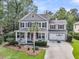Charming two-story home with a welcoming front porch, manicured lawn, and attached two-car garage at 1728 Wellstead St, Mount Pleasant, SC 29466