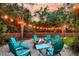 Cozy backyard fire pit area with Adirondack chairs and string lights at 1728 Wellstead St, Mount Pleasant, SC 29466