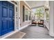 Inviting front porch with comfortable seating, a blue front door, and a view of the neighborhood at 1728 Wellstead St, Mount Pleasant, SC 29466