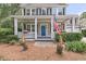 Charming front porch with a blue door, flower baskets, and decorative elements creating an inviting entry at 1728 Wellstead St, Mount Pleasant, SC 29466