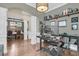 Home office with hardwood floors, built-in shelves, record player and view of dining room at 1728 Wellstead St, Mount Pleasant, SC 29466