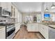 Open kitchen with stainless steel appliances, granite countertops, white cabinets and hardwood floors at 1728 Wellstead St, Mount Pleasant, SC 29466