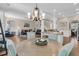 Open-concept living room with hardwood floors, modern lighting, and eat-in kitchen with granite countertops at 1728 Wellstead St, Mount Pleasant, SC 29466