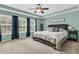 Spacious main bedroom featuring a tray ceiling, large windows, and a plush king-size bed at 1728 Wellstead St, Mount Pleasant, SC 29466