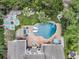 Stunning backyard featuring a luxurious pool area with lounge chairs, a fire pit, and lush landscaping at 1728 Wellstead St, Mount Pleasant, SC 29466