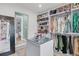 Spacious walk-in closet with custom shelving, a central island with a glass top, and ample hanging space for an organized wardrobe at 1728 Wellstead St, Mount Pleasant, SC 29466