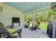 Large porch with outdoor seating overlooking the green and wooded backyard at 196 Dogwood Ridge Rd, Summerville, SC 29485