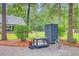 Landscaped backyard featuring a potting bench, outdoor shower, and fire pit seating near a home at 196 Dogwood Ridge Rd, Summerville, SC 29485