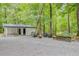 Inviting backyard with a fire pit, seating area, picnic table and detached garage at 196 Dogwood Ridge Rd, Summerville, SC 29485