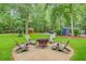 Backyard sitting area with Adirondack chairs surrounding a fire pit, perfect for outdoor gathering at 196 Dogwood Ridge Rd, Summerville, SC 29485