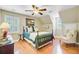Cozy bedroom featuring a wooden four-poster bed, ceiling fan and a sitting area at 196 Dogwood Ridge Rd, Summerville, SC 29485