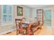 Inviting dining room features a rustic wooden table, chairs, and bench with bright natural light and stylish decor at 196 Dogwood Ridge Rd, Summerville, SC 29485
