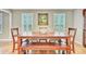 Charming dining room boasts a long wooden table and chairs, perfect for Gathering gatherings and entertaining guests at 196 Dogwood Ridge Rd, Summerville, SC 29485