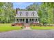 Charming home featuring a metal roof, dormer windows, brick foundation, and a welcoming front porch at 196 Dogwood Ridge Rd, Summerville, SC 29485