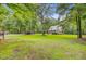 Expansive lawn showcasing a beautiful home, playhouse, shed, and boat storage, embraced by lush trees at 196 Dogwood Ridge Rd, Summerville, SC 29485