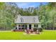 Inviting home exterior featuring a metal roof, covered porch with seating, and a manicured lawn at 196 Dogwood Ridge Rd, Summerville, SC 29485