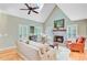Inviting living room featuring a vaulted ceiling, brick fireplace, hardwood floors, and ample natural light at 196 Dogwood Ridge Rd, Summerville, SC 29485
