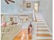 Bright living room featuring hardwood floors, high ceilings, a staircase, and views into the dining room at 196 Dogwood Ridge Rd, Summerville, SC 29485