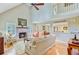 Cozy living room with a brick fireplace, hardwood floors, and a view into the dining area at 196 Dogwood Ridge Rd, Summerville, SC 29485