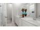 Bright bathroom featuring double sink vanity with white cabinets and a large decorative mirror at 198 Steepbrook Dr, Summerville, SC 29486