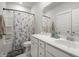 Bathroom with a floral shower curtain, white vanity, and a decorative mirror at 198 Steepbrook Dr, Summerville, SC 29486