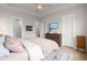 Light and airy main bedroom with hardwood floors, ceiling fan, and ensuite bathroom entrances at 198 Steepbrook Dr, Summerville, SC 29486