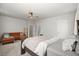 Bright primary bedroom with a wooden bed, an orange couch, and neutral colored carpet at 198 Steepbrook Dr, Summerville, SC 29486