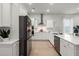 Bright kitchen features white cabinets, stainless steel appliances, and a large center island at 198 Steepbrook Dr, Summerville, SC 29486