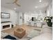 Living room featuring fireplace, ceiling fan, and open access to a modern, white kitchen at 198 Steepbrook Dr, Summerville, SC 29486