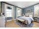 Bright bedroom with large windows, neutral tones, paneled accent wall, and stylish decor at 2026 Sea Water Dr, Charleston, SC 29412