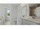 Bright bathroom with double vanity, white cabinets, and view to the yard at 206 Terrace View Dr, Summerville, SC 29486