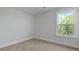 Bright bedroom with a large window offering an outdoor view and neutral carpet flooring at 206 Terrace View Dr, Summerville, SC 29486