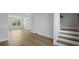 Hallway with wood-look floors and white trim showcasing a stairway and natural light from a window at 206 Terrace View Dr, Summerville, SC 29486