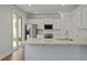 Modern kitchen featuring stainless steel appliances, white cabinets, tile backsplash, and quartz countertops at 206 Terrace View Dr, Summerville, SC 29486