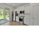 Well-lit kitchen featuring white cabinetry, stainless steel appliances and a sliding glass door to the exterior at 206 Terrace View Dr, Summerville, SC 29486