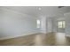 Bright living room featuring wood-look floors, neutral walls, and ample natural light from large windows at 206 Terrace View Dr, Summerville, SC 29486