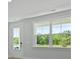 Well-lit living room showcasing a door and windows framing views of a lush green landscape at 206 Terrace View Dr, Summerville, SC 29486
