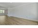 Spacious living room with wood-look floors, white trim and walls, and natural light from a large window at 206 Terrace View Dr, Summerville, SC 29486