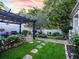 Lush backyard with a pergola, outdoor grill, and beautiful landscaping at 206 White Gables Dr, Summerville, SC 29483