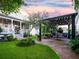 Serene backyard featuring lush landscaping, outdoor seating, and a charming pergola at 206 White Gables Dr, Summerville, SC 29483