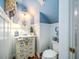 Charming half-bathroom with decorative vanity, beadboard walls, and unique lighting fixtures at 206 White Gables Dr, Summerville, SC 29483