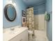 Bathroom with a floral shower curtain, oval mirror, and a classic white vanity at 206 White Gables Dr, Summerville, SC 29483