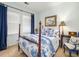 Bedroom featuring a four-poster bed with blue and white bedding, and natural light at 206 White Gables Dr, Summerville, SC 29483