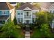 Stunning exterior view of a two-story home with a charming porch and vibrant green shutters at 206 White Gables Dr, Summerville, SC 29483